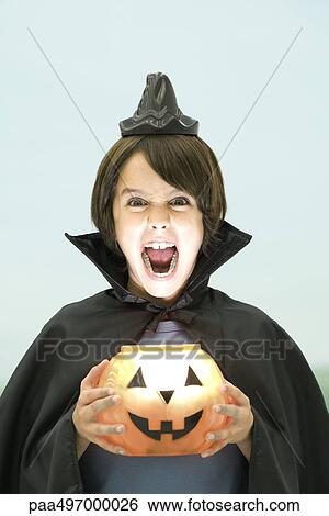 Boy holding jack o' lantern, looking at camera, open mouth, portrait View Large Photo Image Stock Photograph - Boy holding jack o' lantern, looking at camera, open mouth, portrait. Fotosearch