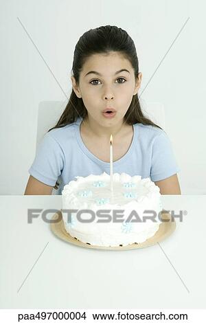 Girl blowing out candle on birthday cake, portrait View Large Photo Image Picture - Girl blowing out candle on birthday cake, portrait. Fotosearch