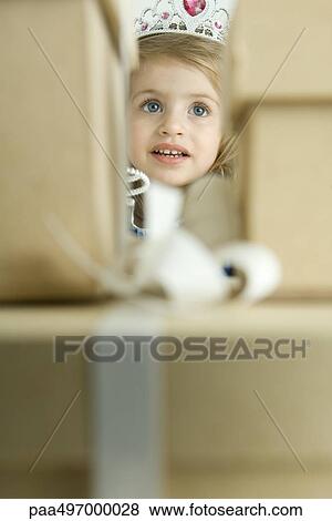 Girl dressed as a princess, peering through stack of gifts View Large Photo Image Stock Photo - Girl dressed as a princess, peering through stack of gifts. Fotosearch
