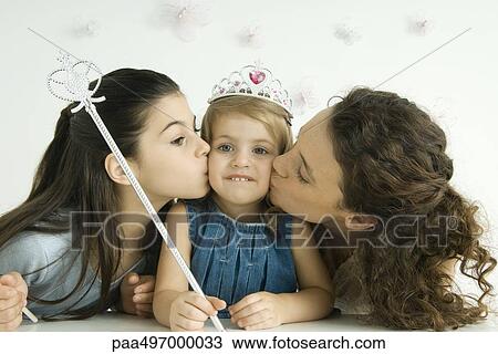Girl dressed as princess, holding wand, mother and sister kissing her cheeks View Large Photo Image Stock Image - Girl dressed as princess, holding wand, mother and sister kissing her cheeks. Fotosearch