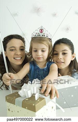 Girl dressed as princess, reaching for presents, mother and sister watching View Large Photo Image Stock Image - Girl dressed as princess, reaching for presents, mother and sister watching. Fotosearch