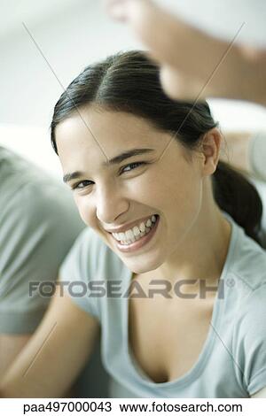 Young woman smiling at camera, portrait View Large Photo Image Stock Image - Young woman smiling at camera, portrait. Fotosearch