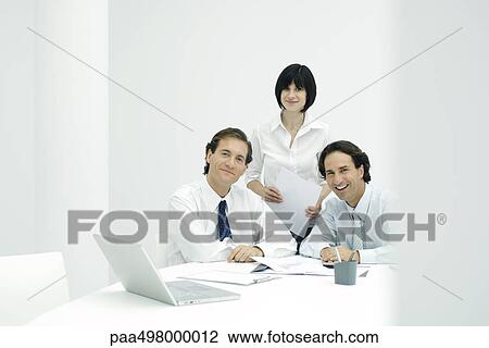 Business associates in office, smiling at camera View Large Photo Image Stock Image - Business associates in office, smiling at camera. Fotosearch