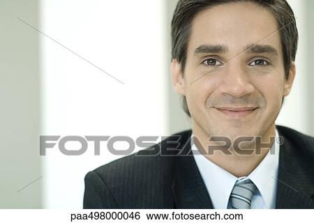 Businessman smiling at camera, portrait View Large Photo Image Stock Photograph - Businessman smiling at camera, portrait. Fotosearch