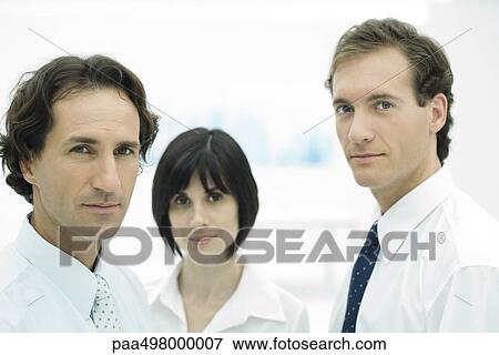 Professionals looking at camera, focus on foreground View Large Photo Image Stock Photo - Professionals looking at camera, focus on foreground. Fotosearch