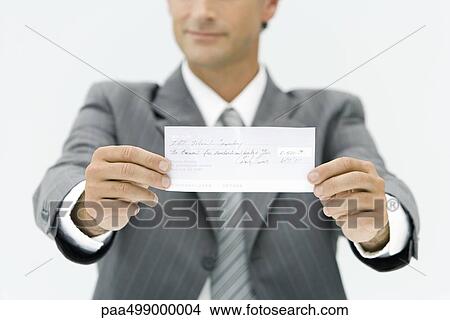 Businessman holding out check, cropped view View Large Photo Image Picture - Businessman holding out check, cropped view. Fotosearch