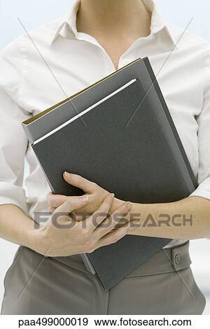 Female professional holding folders, cropped view View Large Photo Image Stock Photo - Female professional holding folders, cropped view. Fotosearch