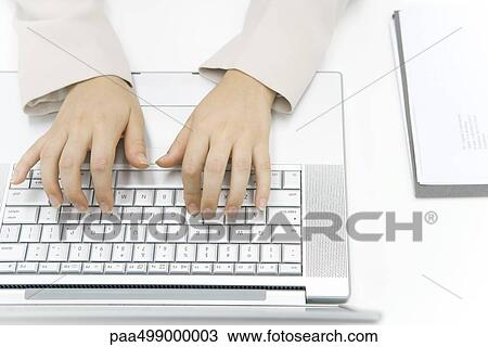 Person typing on laptop computer, cropped view of hands, overhead view View Large Photo Image Stock Image - Person typing on laptop computer, cropped view of hands, overhead view. Fotosearch