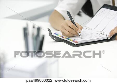Person writing in agenda, cropped view View Large Photo Image Stock Image - Person writing in agenda, cropped view. Fotosearch