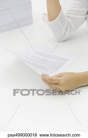Stock Photo - Woman holding document, cropped view. Fotosearch