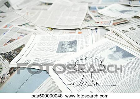 Stock Photo - Drawing of tree on pile of newspaper. Fotosearch