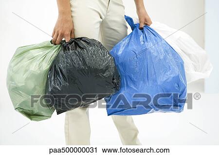 Female carrying several bags of garbage, cropped view View Large Photo Image Stock Image - Female carrying several bags of garbage, cropped view. Fotosearch