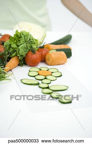 Stock Image - Fresh vegetable slices arranged in shape of flower, close-up. Fotosearch