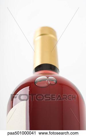 Bottle of rose wine, close-up, low angle view View Large Photo Image Stock Image - Bottle of rose wine, close-up, low angle view. Fotosearch