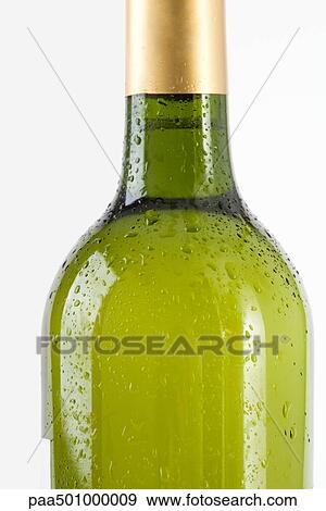 Stock Photo - Bottle of white wine covered with drops of water, cropped. Fotosearch