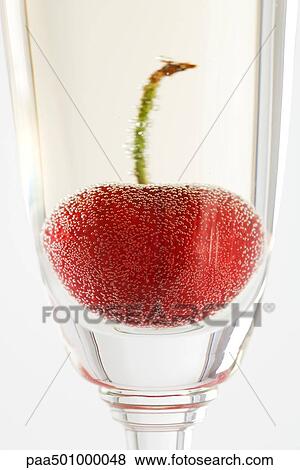 Cherry in glass of champagne, close-up View Large Photo Image Stock Photo - Cherry in glass of champagne, close-up. Fotosearch