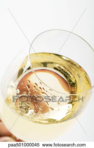 Glass of chilled white wine, close-up, high angle view View Large Photo Image Stock Photography - Glass of chilled white wine, close-up, high angle view. Fotosearch