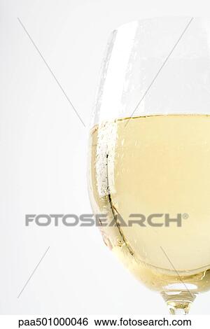 Glass of white wine with condensation, cropped View Large Photo Image Stock Photograph - Glass of white wine with condensation, cropped. Fotosearch