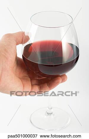 Stock Photo - Hand holding glass of red wine. Fotosearch