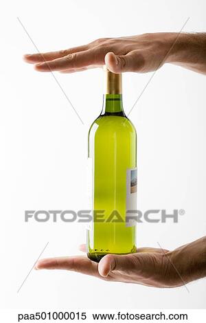 Hands holding bottle of white wine View Large Photo Image Stock Photography - Hands holding bottle of white wine. Fotosearch