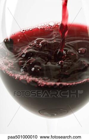 Red wine pouring into glass, close-up View Large Photo Image Stock Image - Red wine pouring into glass, close-up. Fotosearch