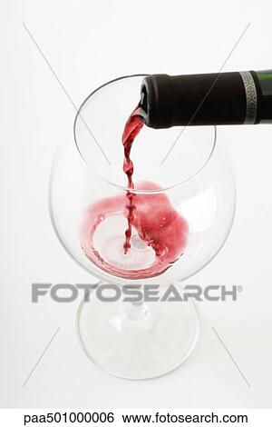 Red wine pouring into wine glass, close-up View Large Photo Image Stock Photograph - Red wine pouring into wine glass, close-up. Fotosearch