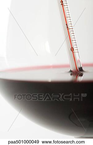 Thermometer in glass of red wine, extreme close-up View Large Photo Image Stock Photo - Thermometer in glass of red wine, extreme close-up. Fotosearch