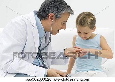 Doctor examining girl's fingers View Large Photo Image Stock Photograph - Doctor examining girl's fingers. Fotosearch