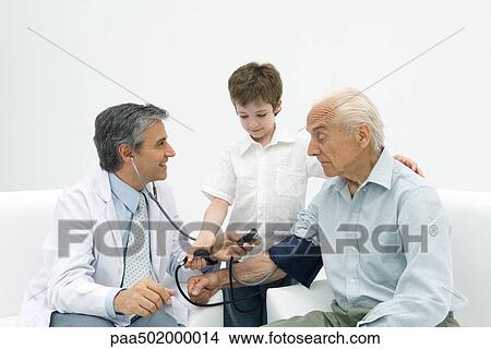 Picture - Doctor measuring senior man's blood pressure, boy helping. Fotosearch