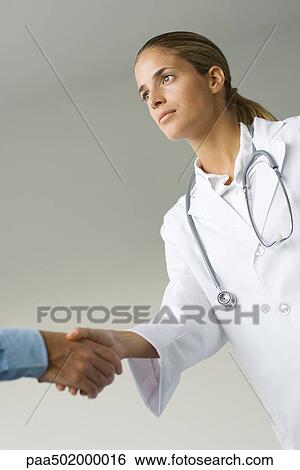 Female doctor shaking man's hand, low angle view, cropped View Large Photo Image Stock Photograph - Female doctor shaking man's hand, low angle view, cropped. Fotosearch
