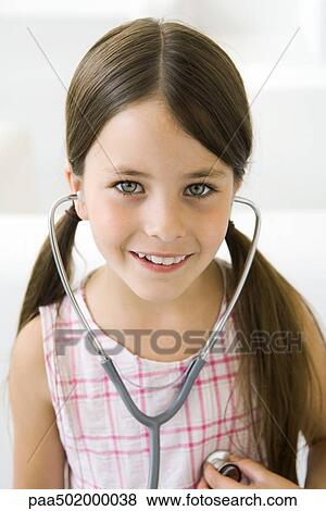 Stock Photo - Girl listening to her own heart through stethoscope. Fotosearch