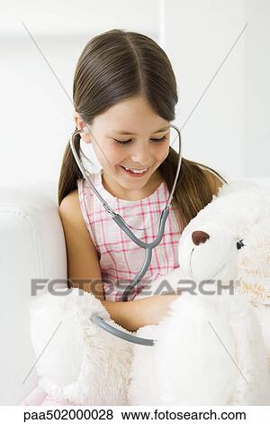 Girl listening to teddy's bear's heart with stethoscope View Large Photo Image Stock Photo - Girl listening to teddy's bear's heart with stethoscope. Fotosearch