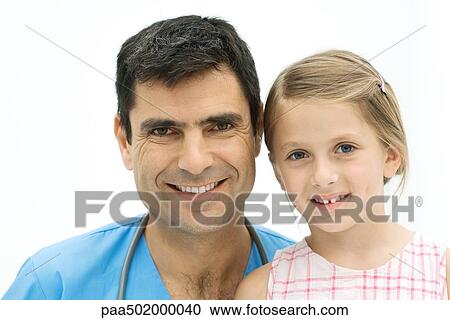 Male nurse together with girl, both smiling at camera, portrait View Large Photo Image Stock Image - Male nurse together with girl, both smiling at camera, portrait. Fotosearch