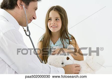 Pediatrician pretending to examine girl's teddy bear with stethoscope View Large Photo Image Stock Image - Pediatrician pretending to examine girl's teddy bear with stethoscope. Fotosearch