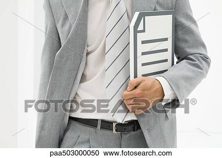 Businessman carrying document, cropped view of mid section View Large Photo Image Stock Image - Businessman carrying document, cropped view of mid section. Fotosearch