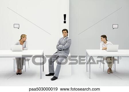 Man sitting in office with exclamation mark over his head, women on either side with blank word bubbles View Large Photo Image Stock Photo - Man sitting in office with exclamation mark over his head, women on either side with blank word bubbles. Fotosearch