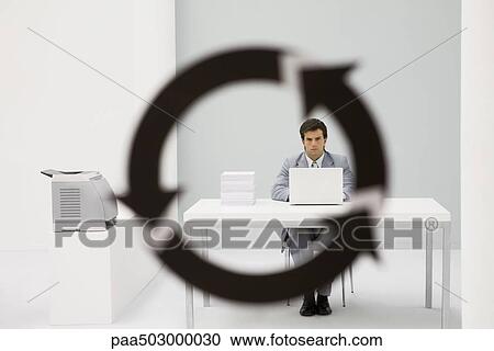 Professional man sitting in office, looking at camera through arrow symbol in foreground View Large Photo Image Stock Image - Professional man sitting in office, looking at camera through arrow symbol in foreground. Fotosearch