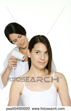 Hair stylist blow drying a woman's hair View Large Photo Image Stock Image - Hair stylist blow drying a woman's hair. Fotosearch