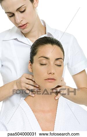Massage therapist giving woman neck massage, eyes closed View Large Photo Image Stock Image - Massage therapist giving woman neck massage, eyes closed. Fotosearch