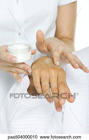 Woman applying cream to another woman's hand, cropped view View Large Photo Image Stock Image - Woman applying cream to another woman's hand, cropped view. Fotosearch