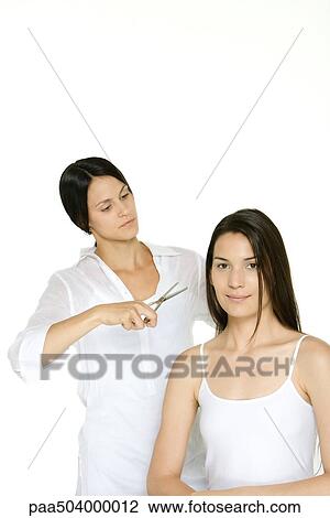 Woman getting her hair cut by stylist, smiling at camera View Large Photo Image Stock Image - Woman getting her hair cut by stylist, smiling at camera. Fotosearch