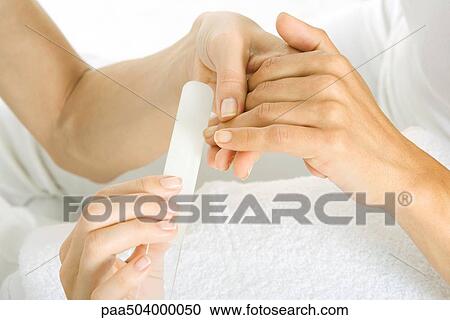 Woman getting her nails filed, cropped view of hands View Large Photo Image Stock Image - Woman getting her nails filed, cropped view of hands. Fotosearch