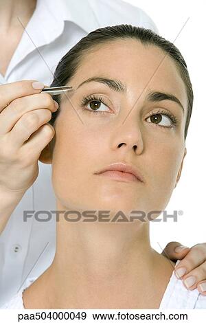 Woman having her eyebrows tweezed, looking up View Large Photo Image Stock Photo - Woman having her eyebrows tweezed, looking up. Fotosearch