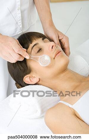 Woman having her face exfoliated, cropped view of woman using facial brush View Large Photo Image Stock Photo - Woman having her face exfoliated, cropped view of woman using facial brush. Fotosearch
