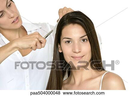 Woman having her hair cut by stylist, smiling at camera View Large Photo Image Stock Photo - Woman having her hair cut by stylist, smiling at camera. Fotosearch