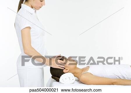 Woman lying on her back receiving head massage, eyes closed View Large Photo Image Stock Image - Woman lying on her back receiving head massage, eyes closed. Fotosearch