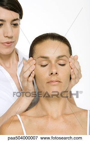 Stock Photo - Woman receiving head massage, eyes closed. Fotosearch