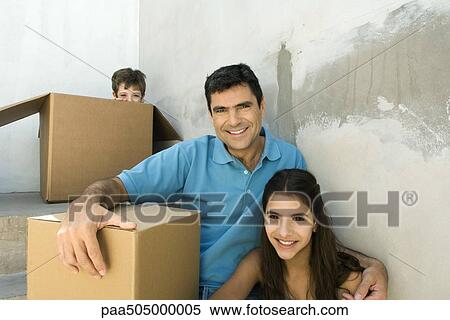 Family sitting on stairwell with cardboard boxes, boy hiding View Large Photo Image Stock Photography - Family sitting on stairwell with cardboard boxes, boy hiding. Fotosearch
