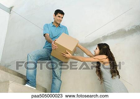 Father and daughter moving cardboard box together, low angle view View Large Photo Image Stock Image - Father and daughter moving cardboard box together, low angle view. Fotosearch