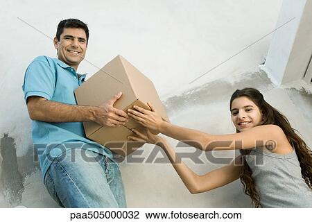Father and daughter moving cardboard box together, low angle view View Large Photo Image Stock Image - Father and daughter moving cardboard box together, low angle view. Fotosearch